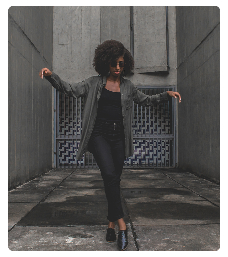 A young woman posing in a fashion shoot in the city