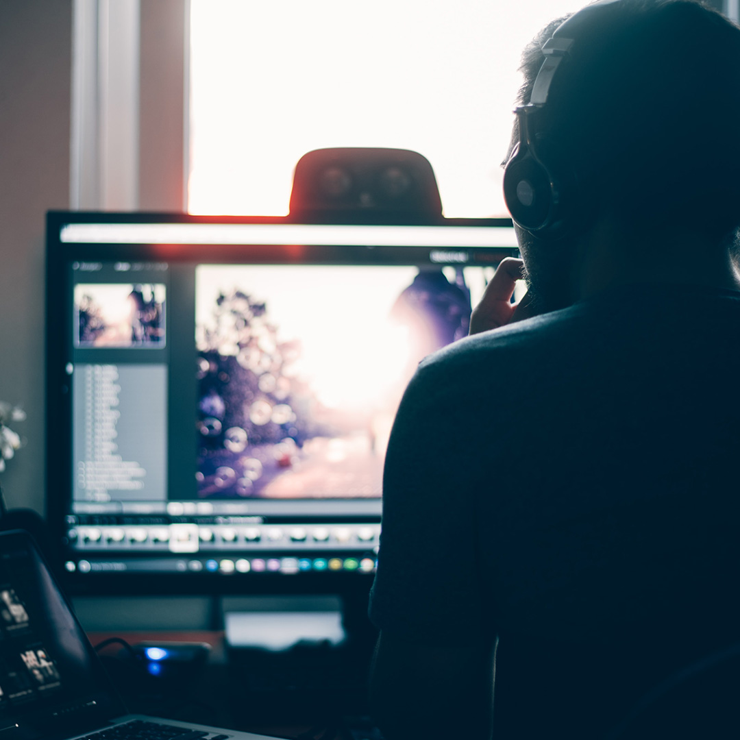 A photographer editing photos at their laptop